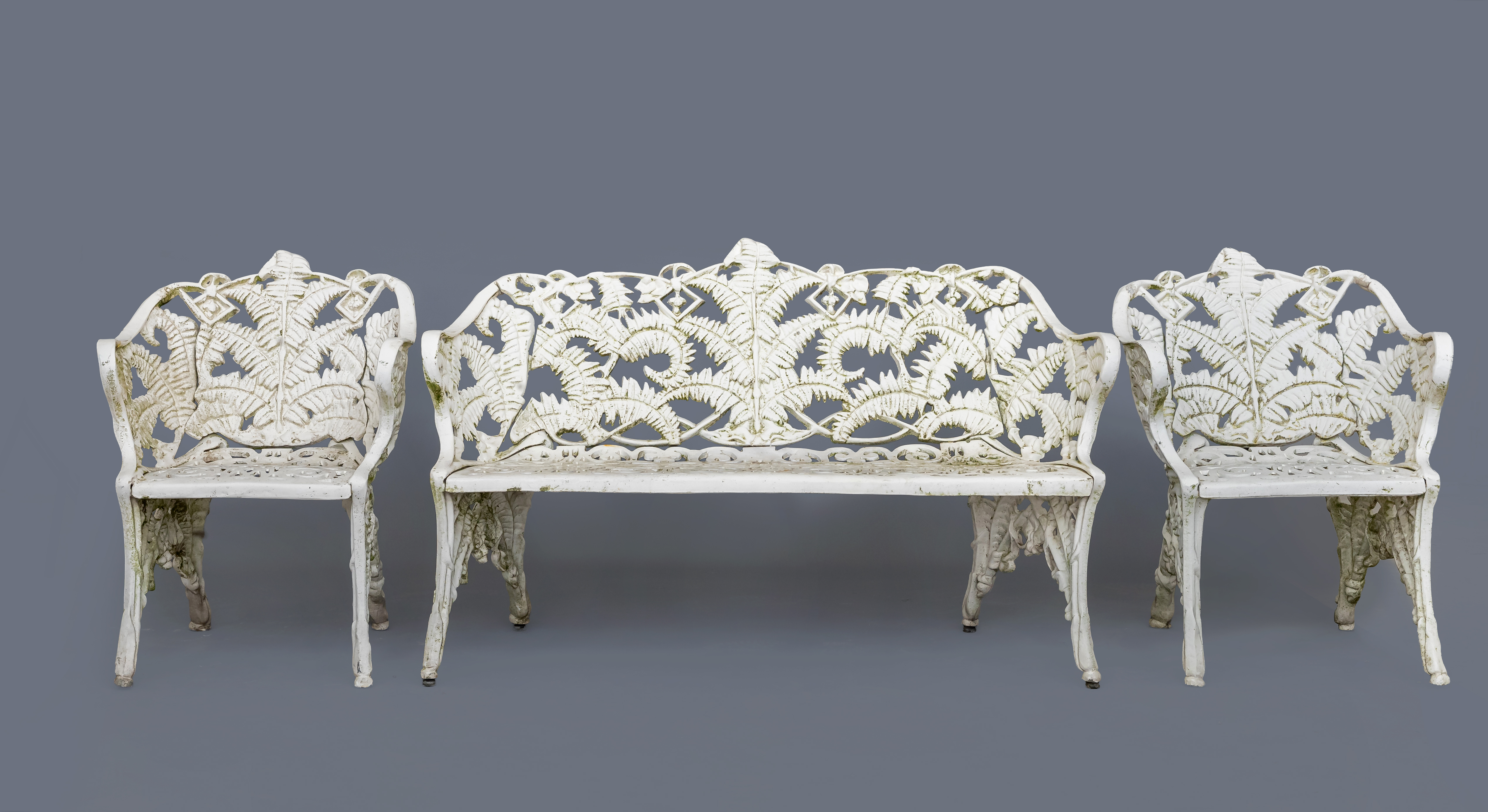 A CAST METAL FIVE PIECE FERN PATTERN SUITE Image