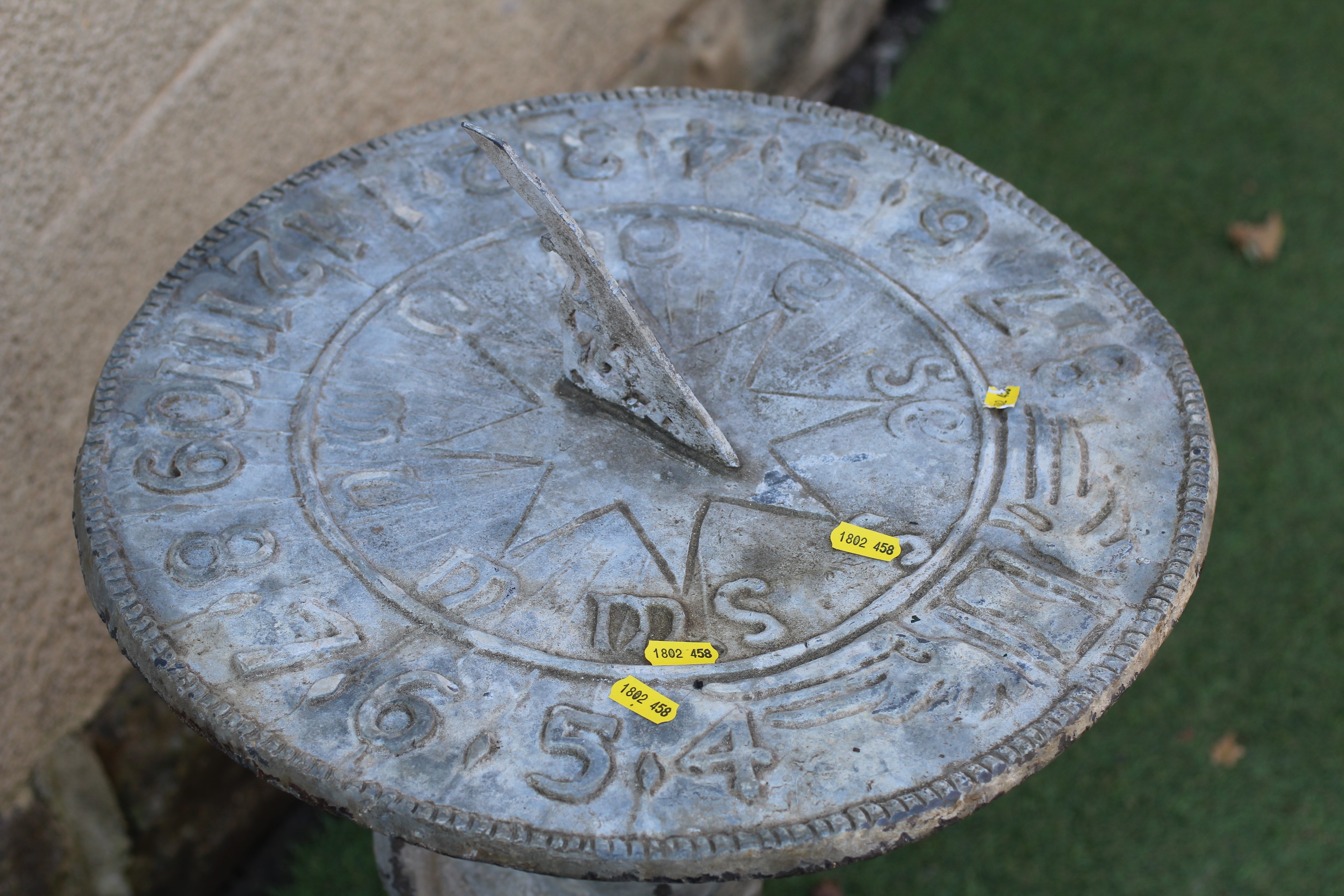 A LEAD FIGURAL SUNDIAL, modern, held aloft by a cherub, on domed base, 16 1/2" w x 31" h Image