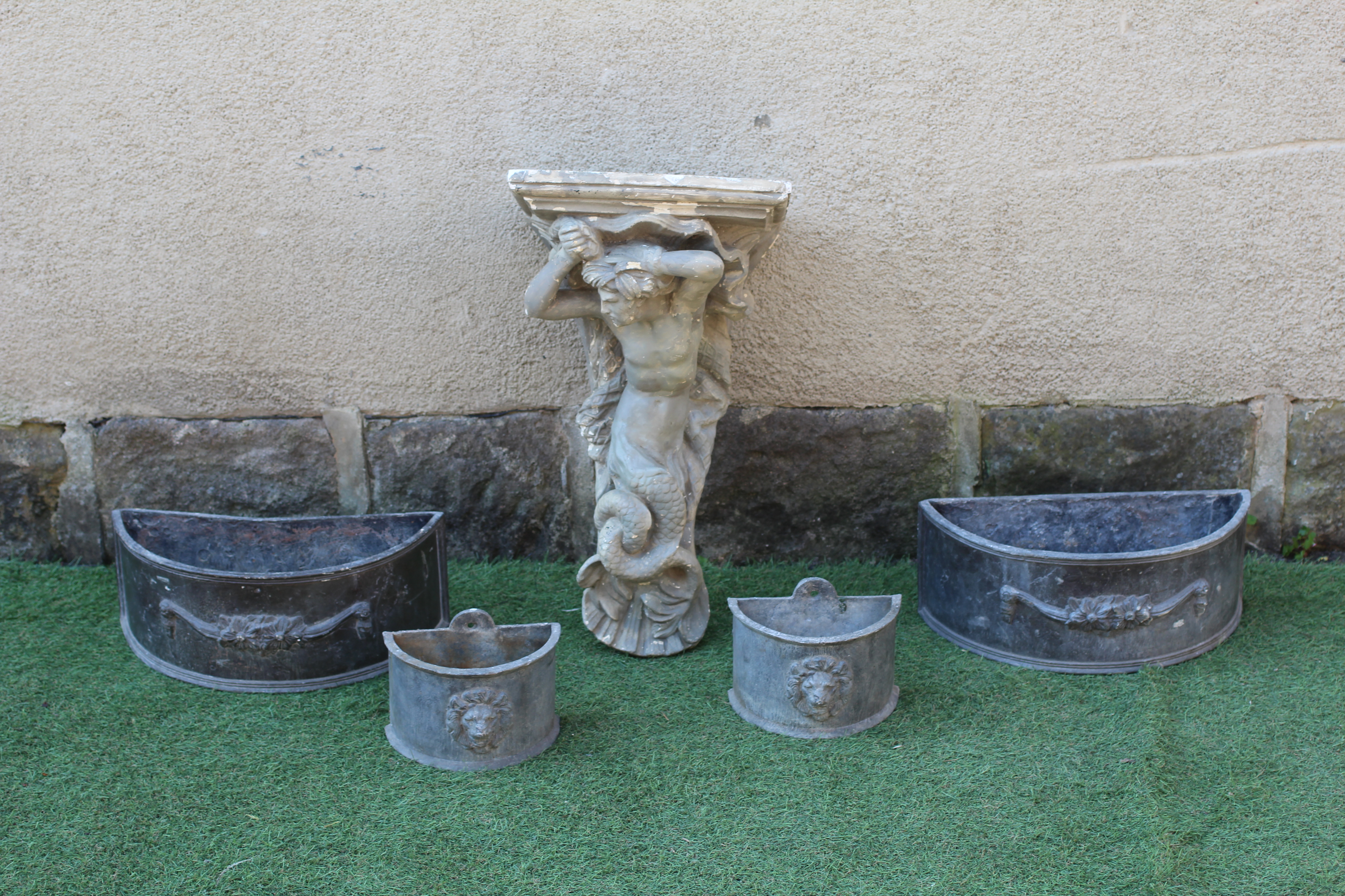 TWO PAIRS OF SMALL LEAD PLANTERS of demi lune form with lion mask and floral swags in high relief Image