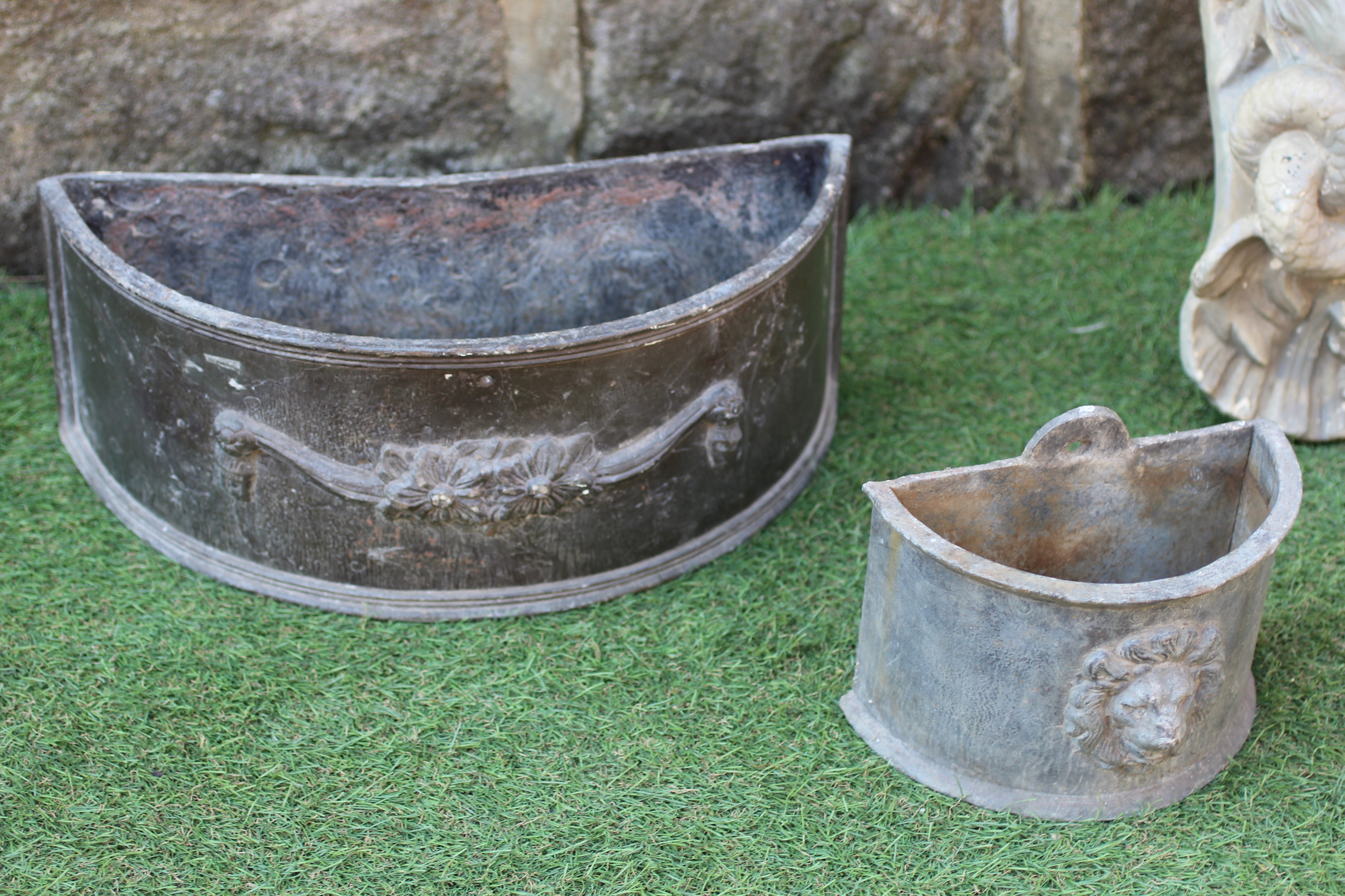 TWO PAIRS OF SMALL LEAD PLANTERS of demi lune form with lion mask and floral swags in high relief Image
