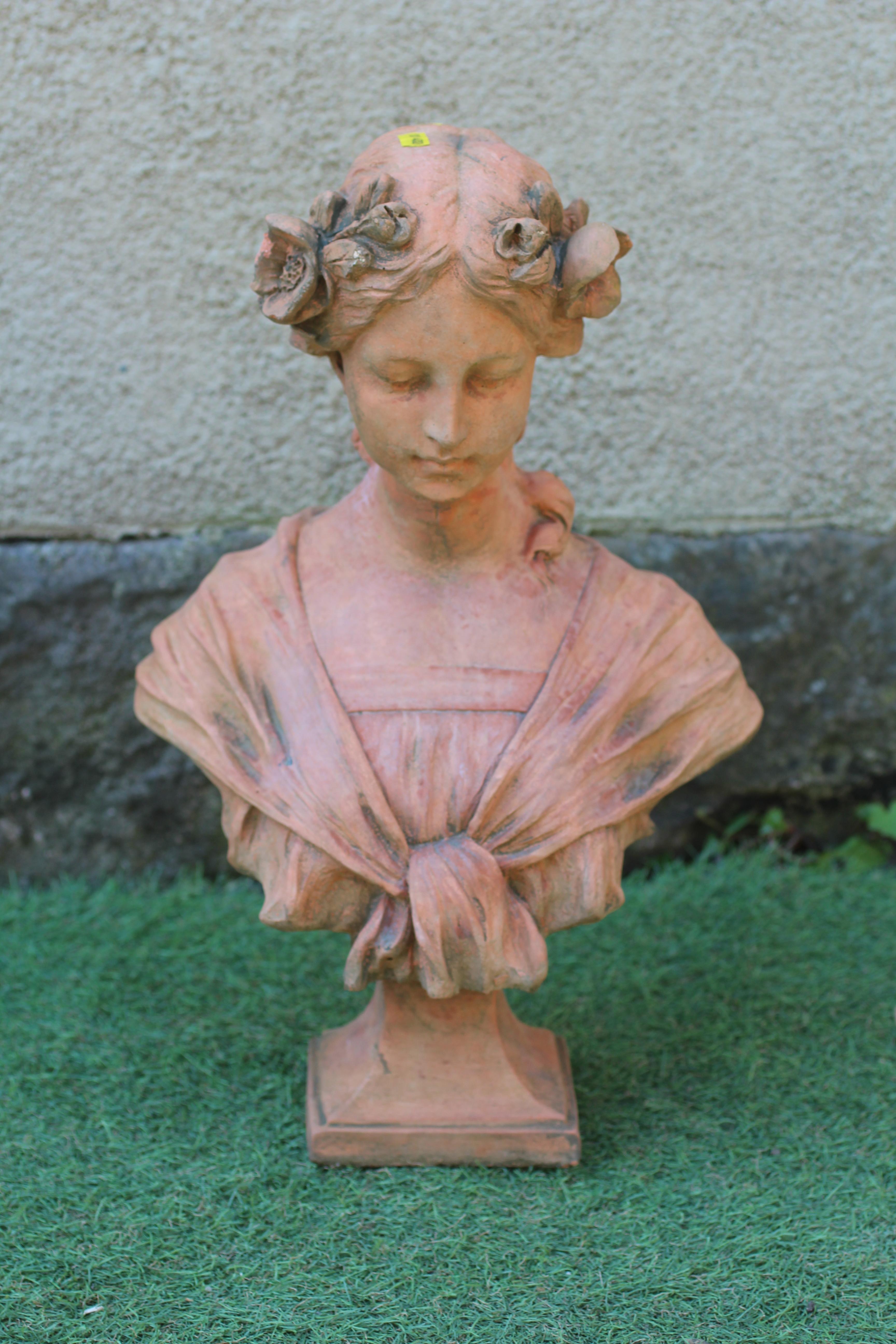 A CAST TERRACOTTA BUST OF A YOUNG MAIDEN modelled with flowers in her hair, on waisted socle and Image