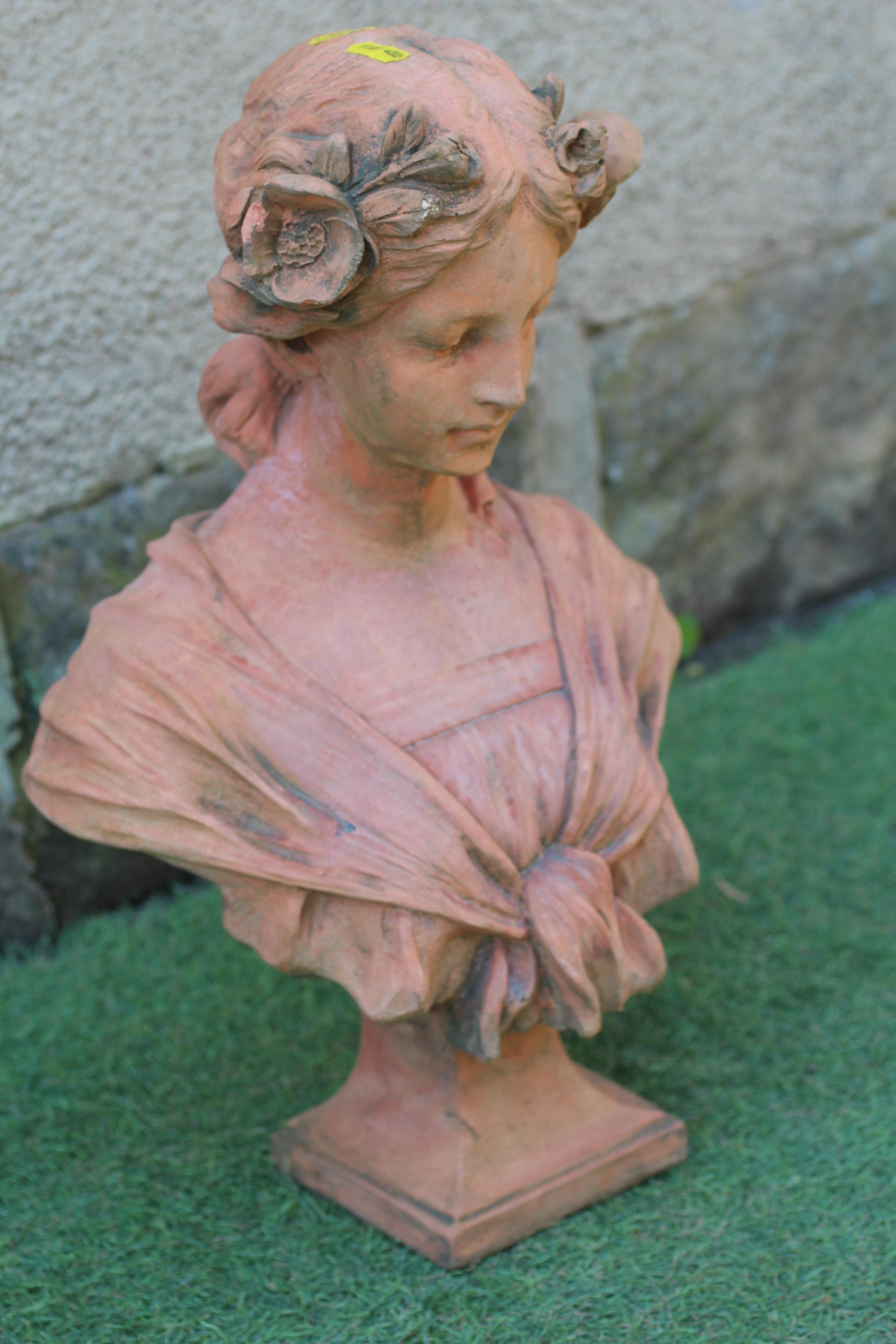 A CAST TERRACOTTA BUST OF A YOUNG MAIDEN modelled with flowers in her hair, on waisted socle and Image