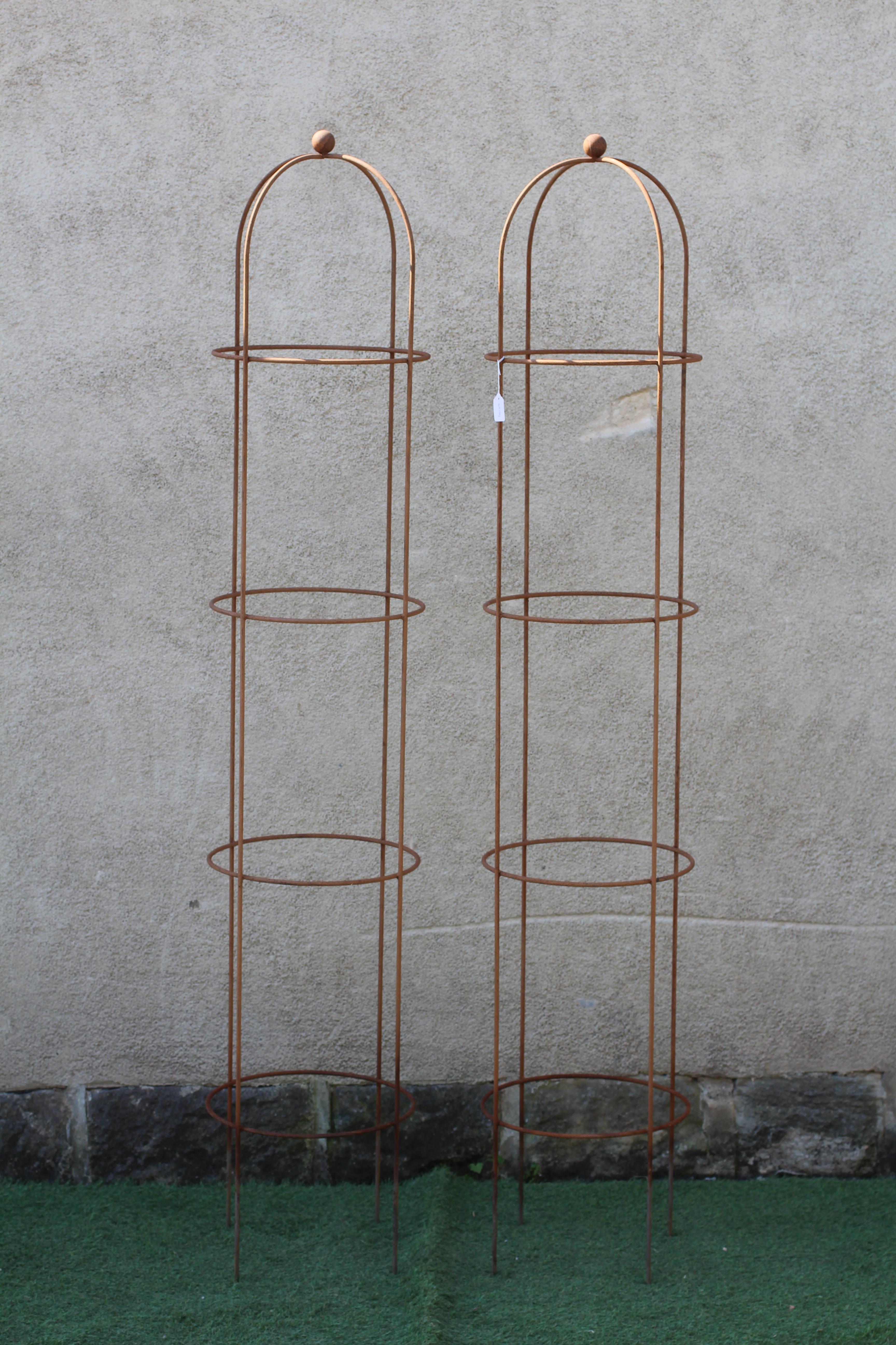 A PAIR OF RUSTED METAL CONICAL ROSE OBELISKS, the domed top with ball finial, 15" w x 80" h Image