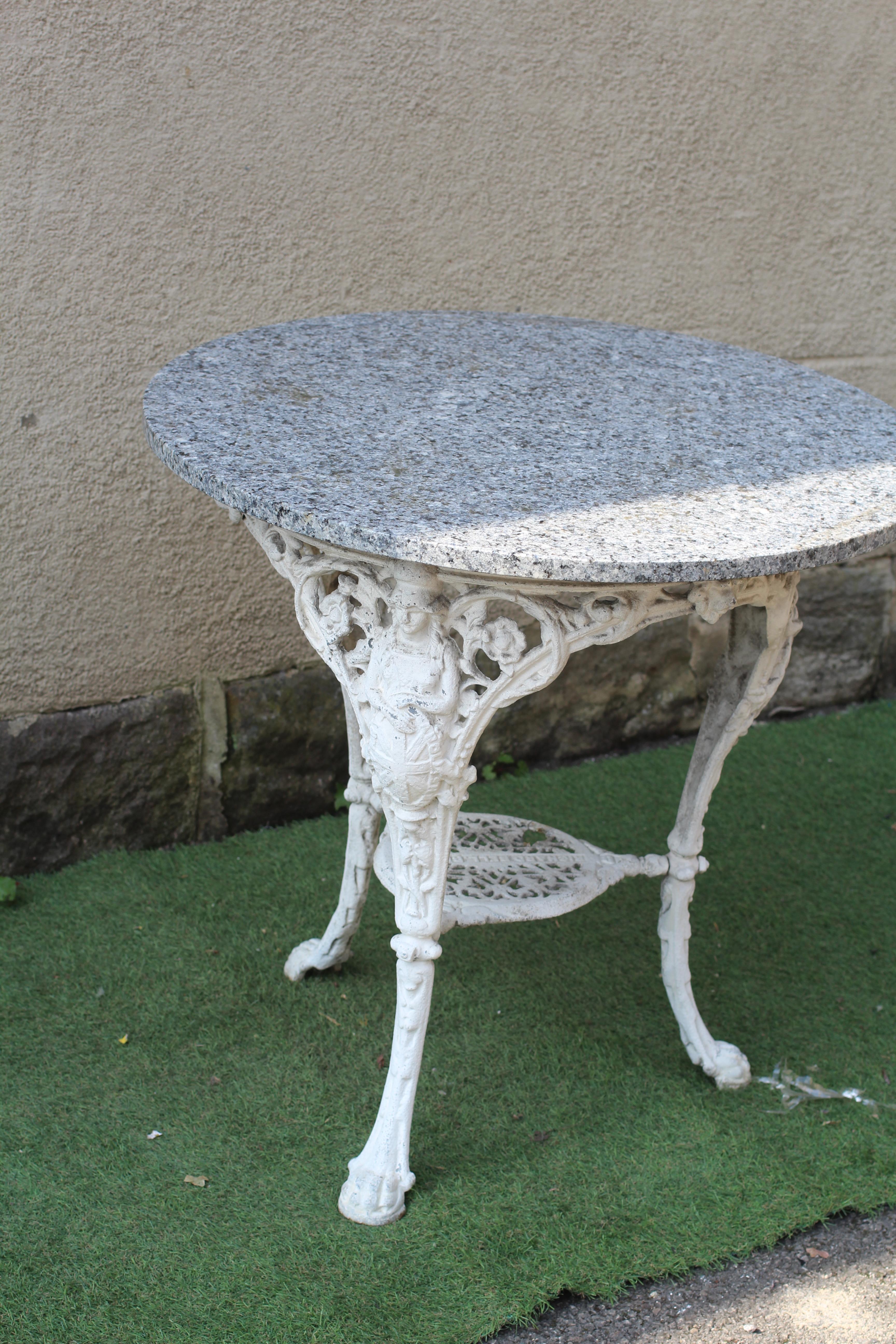 A VICTORIAN CAST IRON BRITANNIA PATTERN PUB TABLE with later circular granite top, the undershelf Image