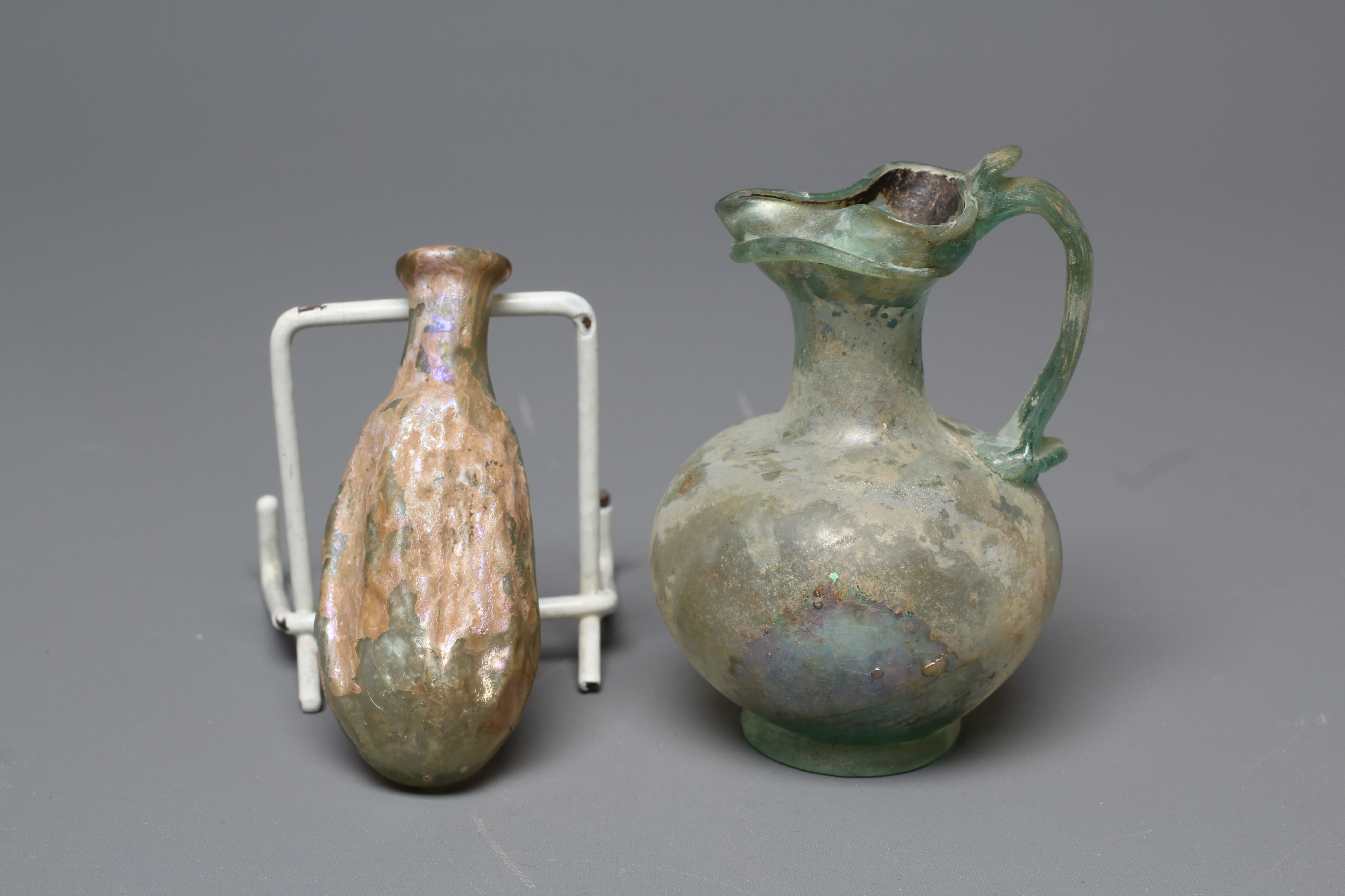 A ROMAN GREEN GLASS JUG, 3rd-4th century AD, with trefoil lip and pulled handle, 3 1/2" high, Image