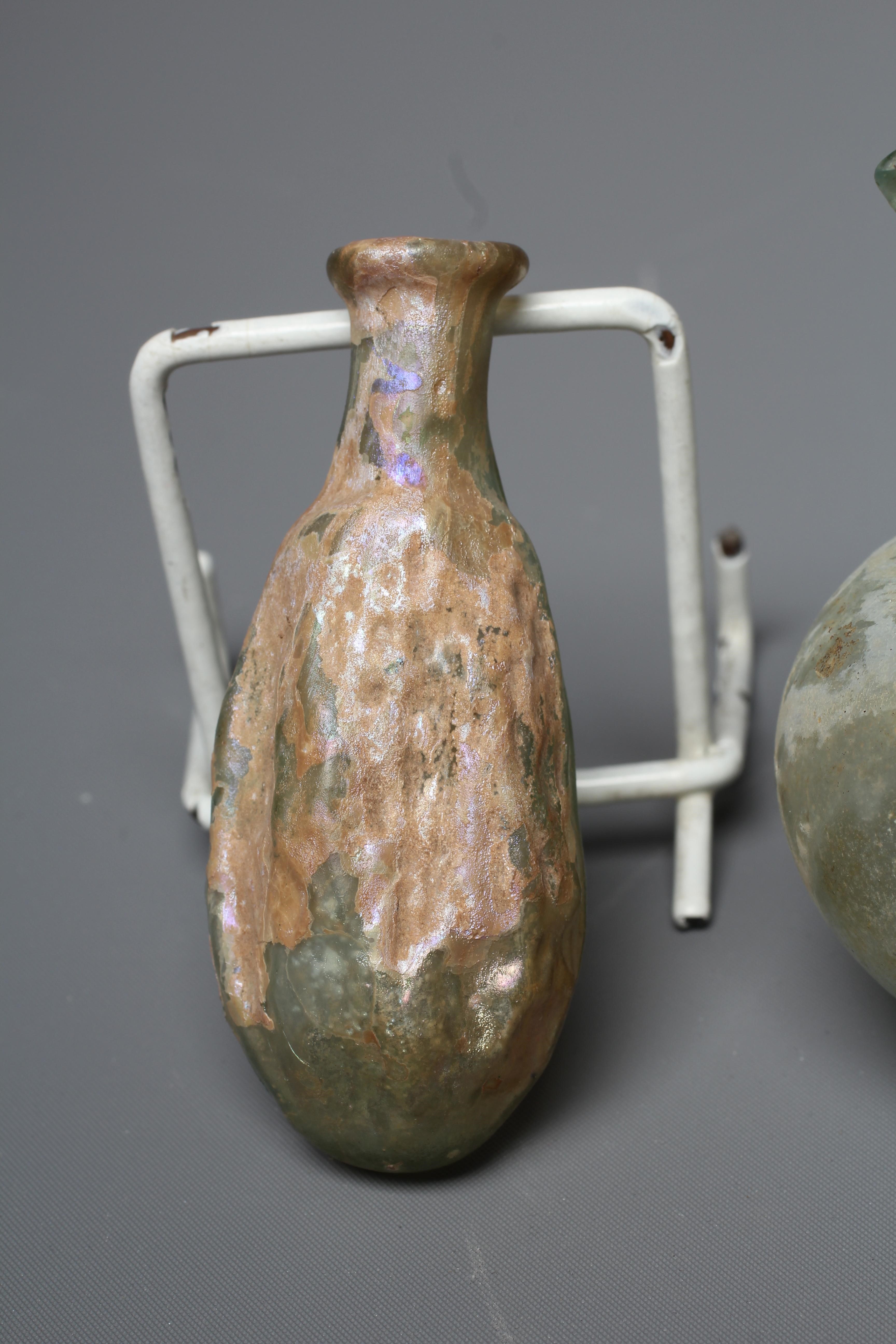 A ROMAN GREEN GLASS JUG, 3rd-4th century AD, with trefoil lip and pulled handle, 3 1/2" high, Image