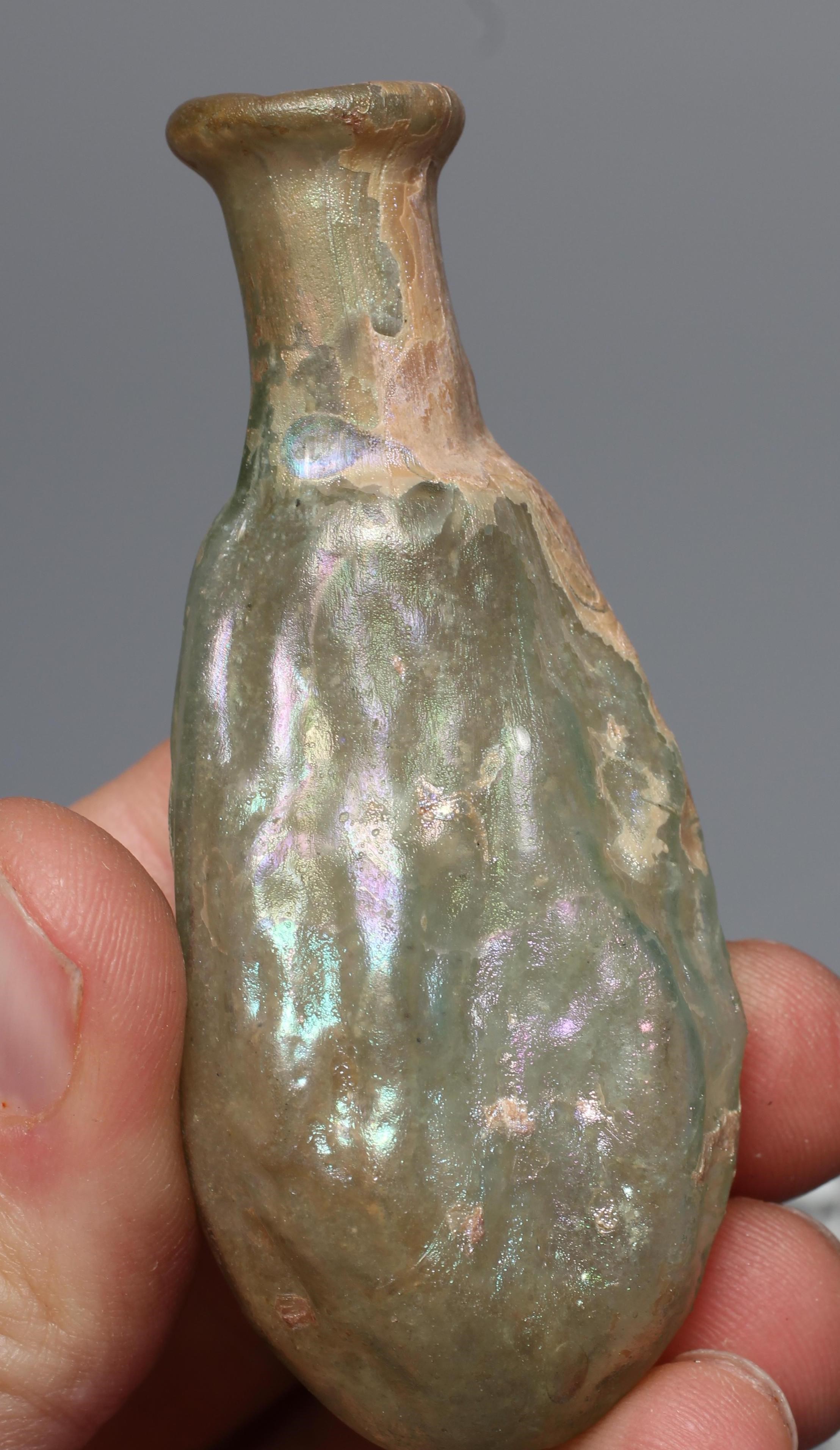 A ROMAN GREEN GLASS JUG, 3rd-4th century AD, with trefoil lip and pulled handle, 3 1/2" high, Image