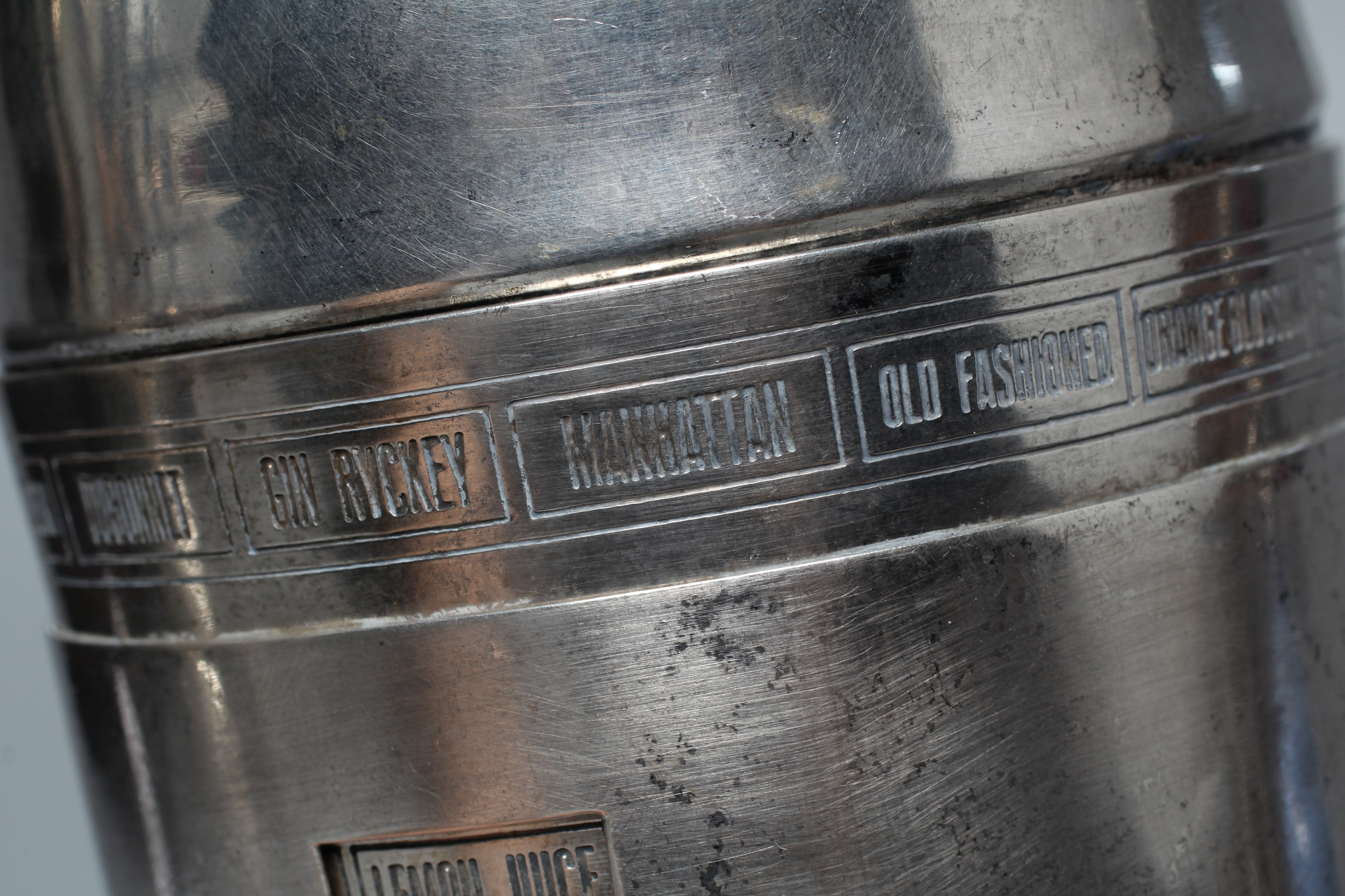 AN ART DECO TORPEDO SHAPED RECIPE COCKTAIL SHAKER by Wilhelm Wolf, the rim with fifteen named Image