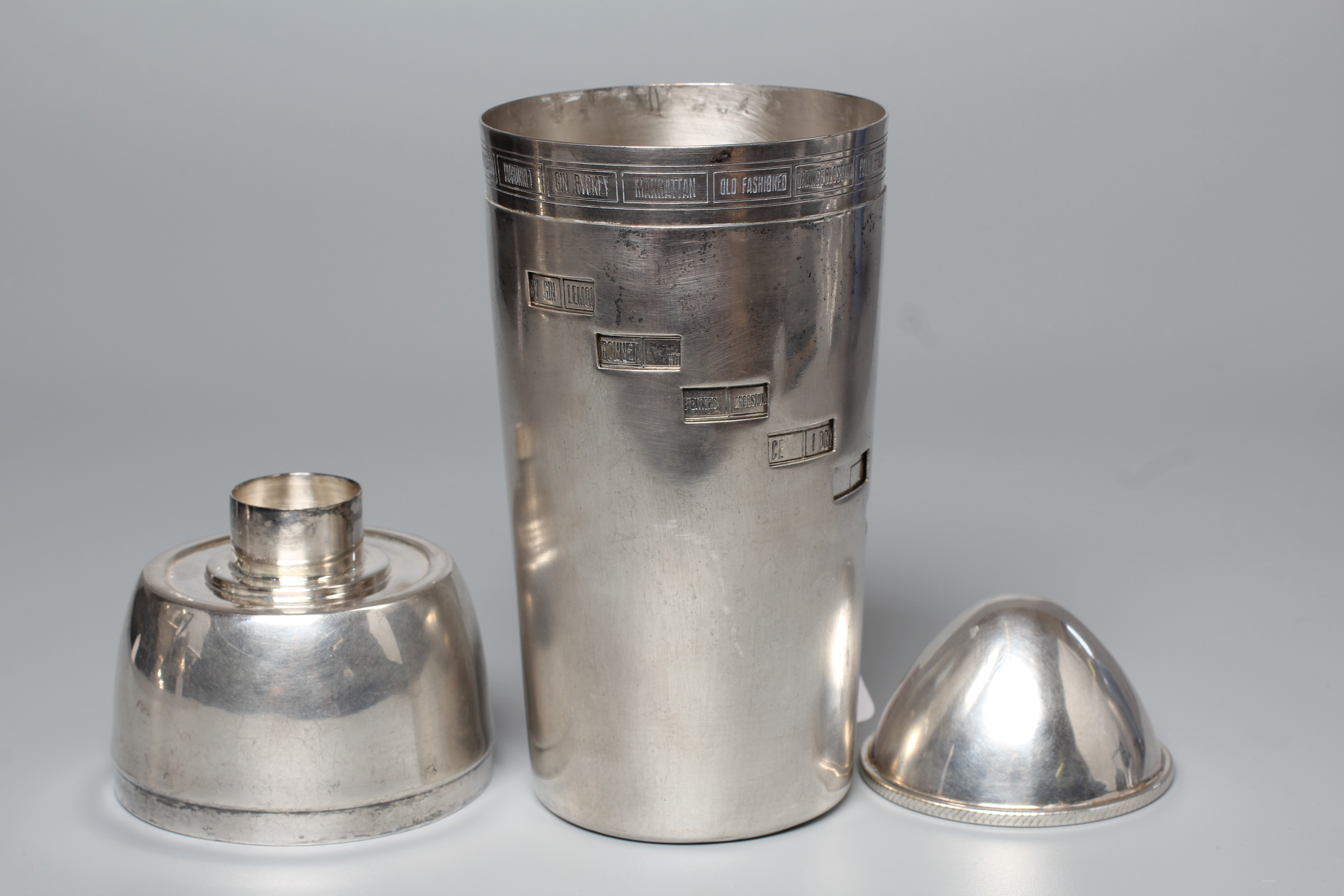 AN ART DECO TORPEDO SHAPED RECIPE COCKTAIL SHAKER by Wilhelm Wolf, the rim with fifteen named Image