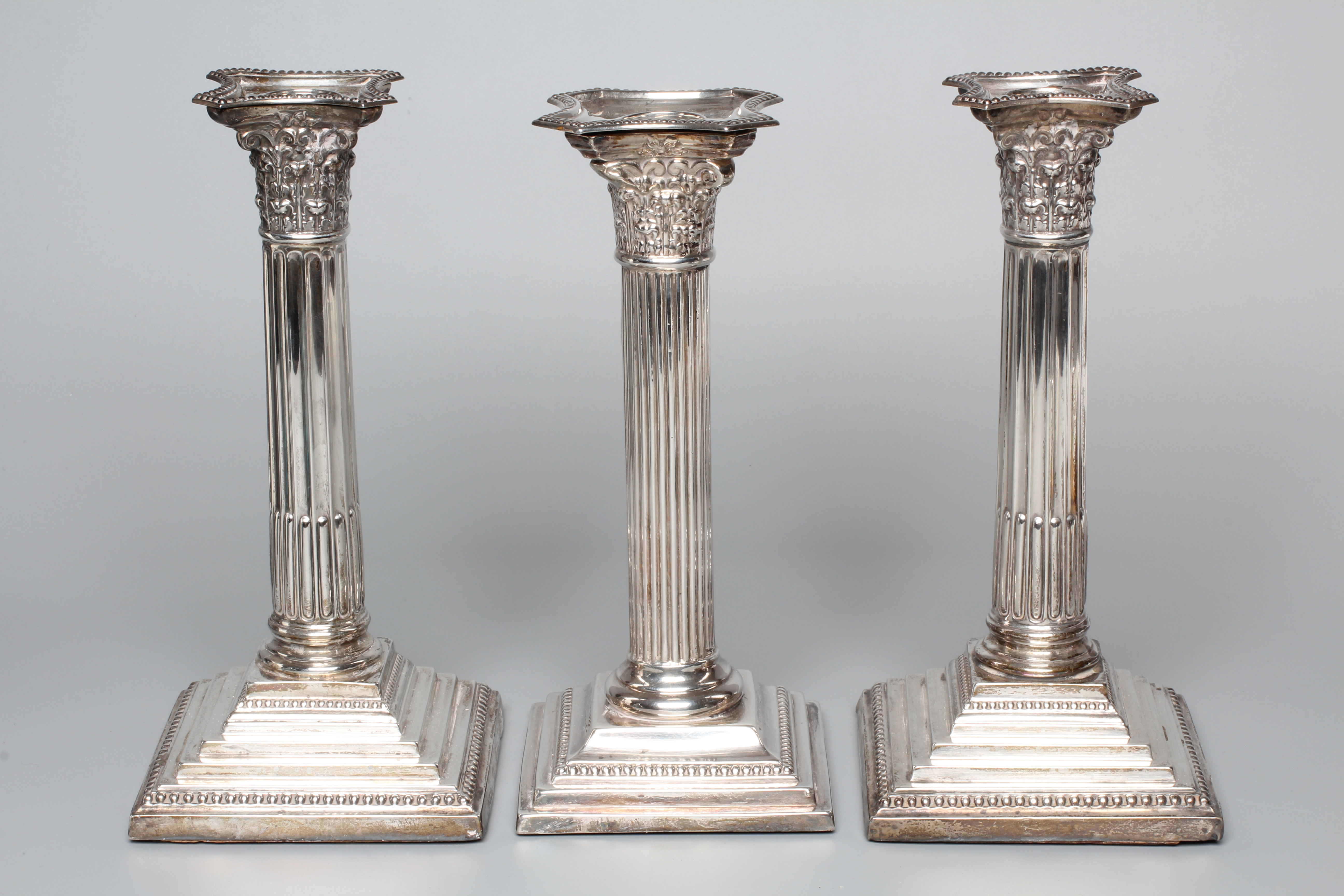 A PAIR OF GEORGE V CORINTHIAN COLUMN CANDLESTICKS by Atkin Brothers, Sheffield 1925, with detachable Image