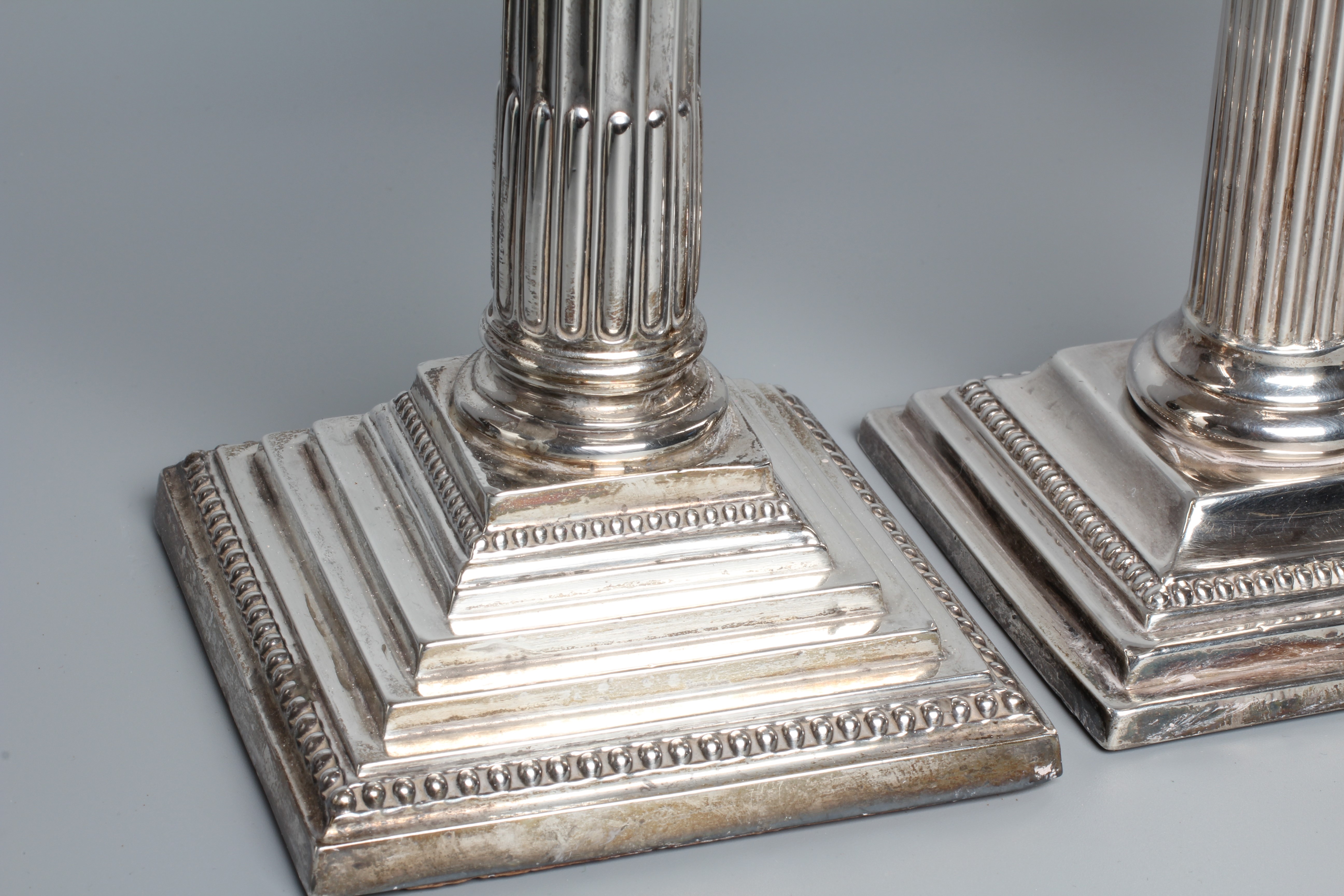 A PAIR OF GEORGE V CORINTHIAN COLUMN CANDLESTICKS by Atkin Brothers, Sheffield 1925, with detachable Image