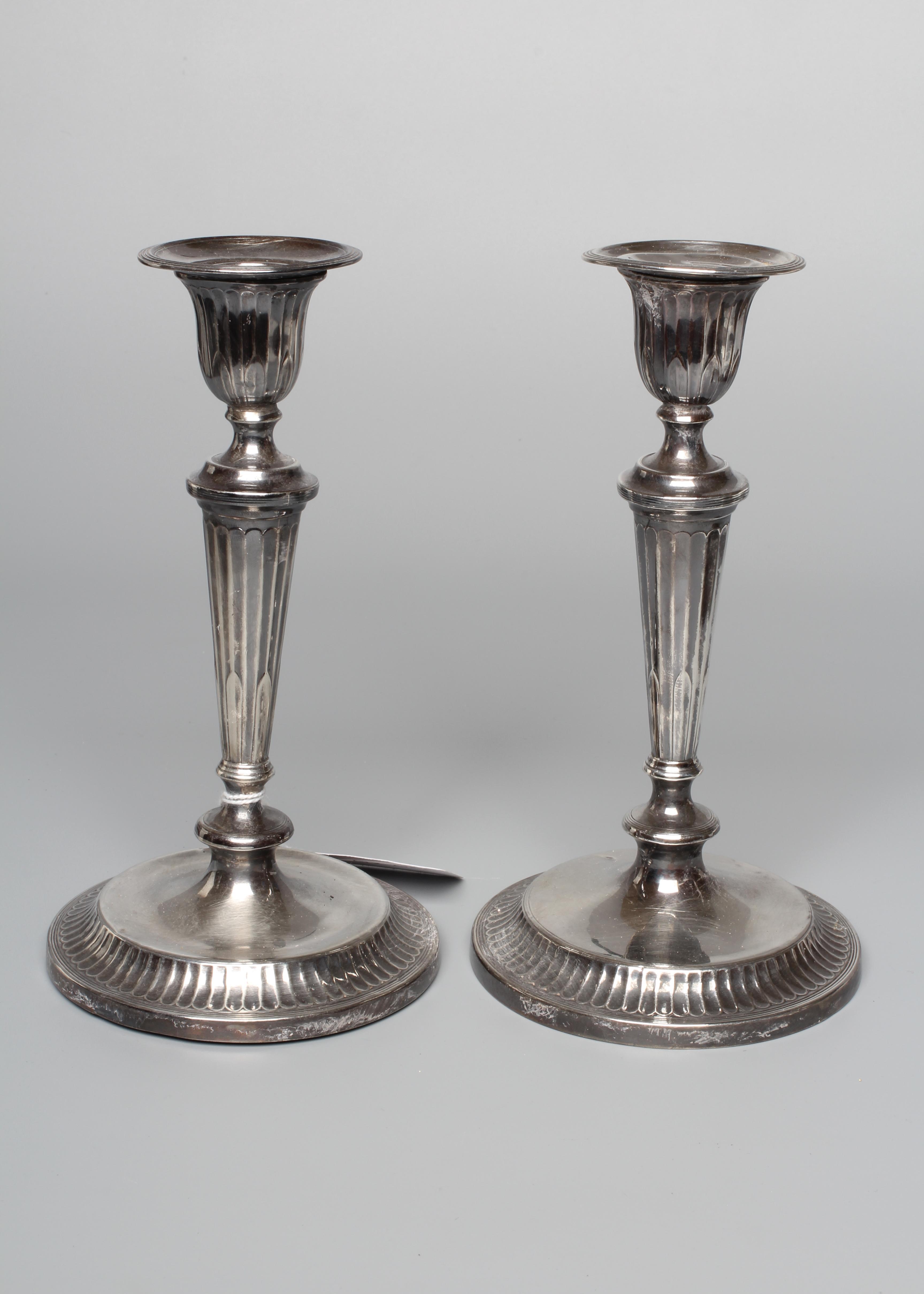 A PAIR OF GEORGE V CANDLESTICKS by Thomas Bradbury and retailed by Barraclough of Leeds Image