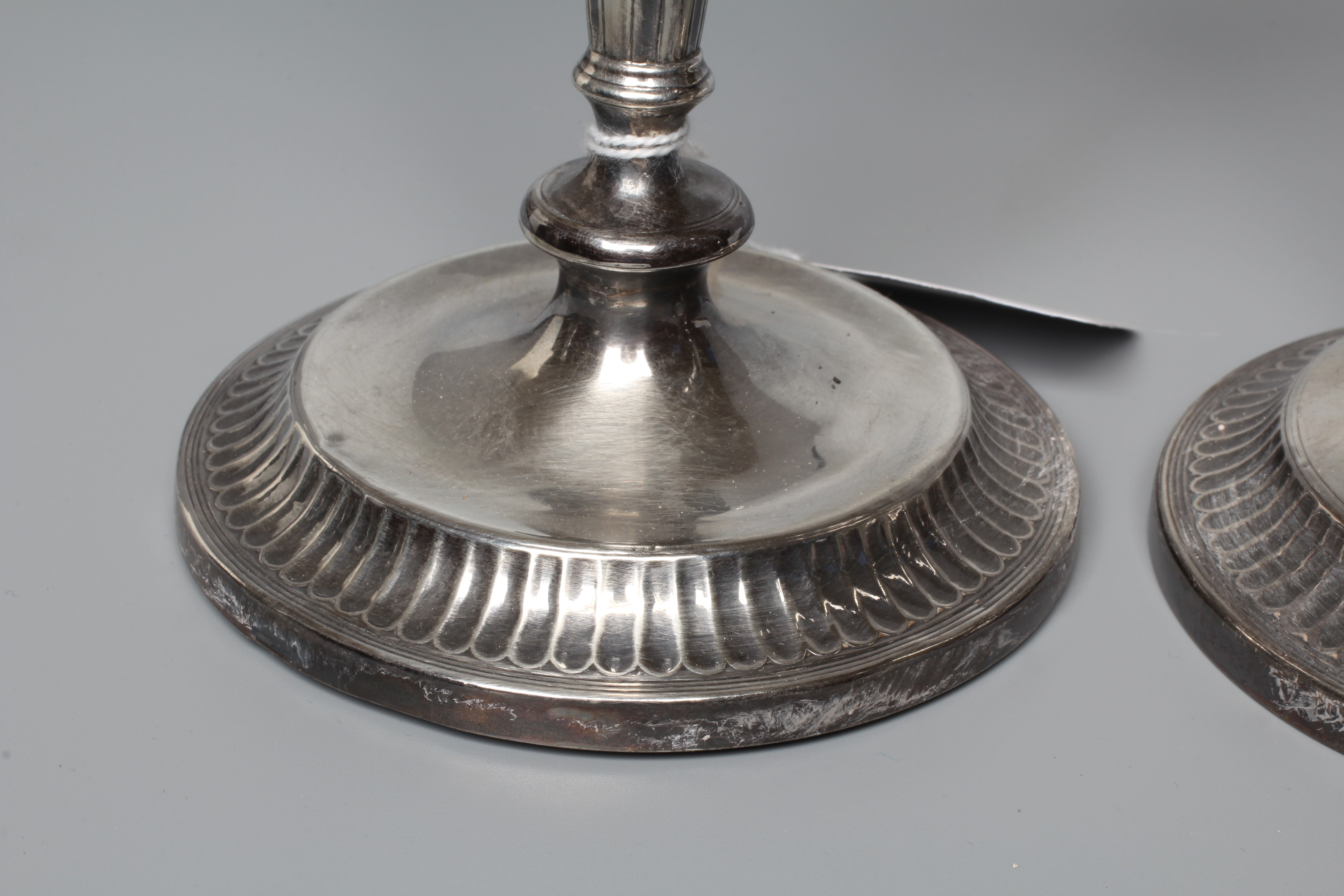 A PAIR OF GEORGE V CANDLESTICKS by Thomas Bradbury and retailed by Barraclough of Leeds Image