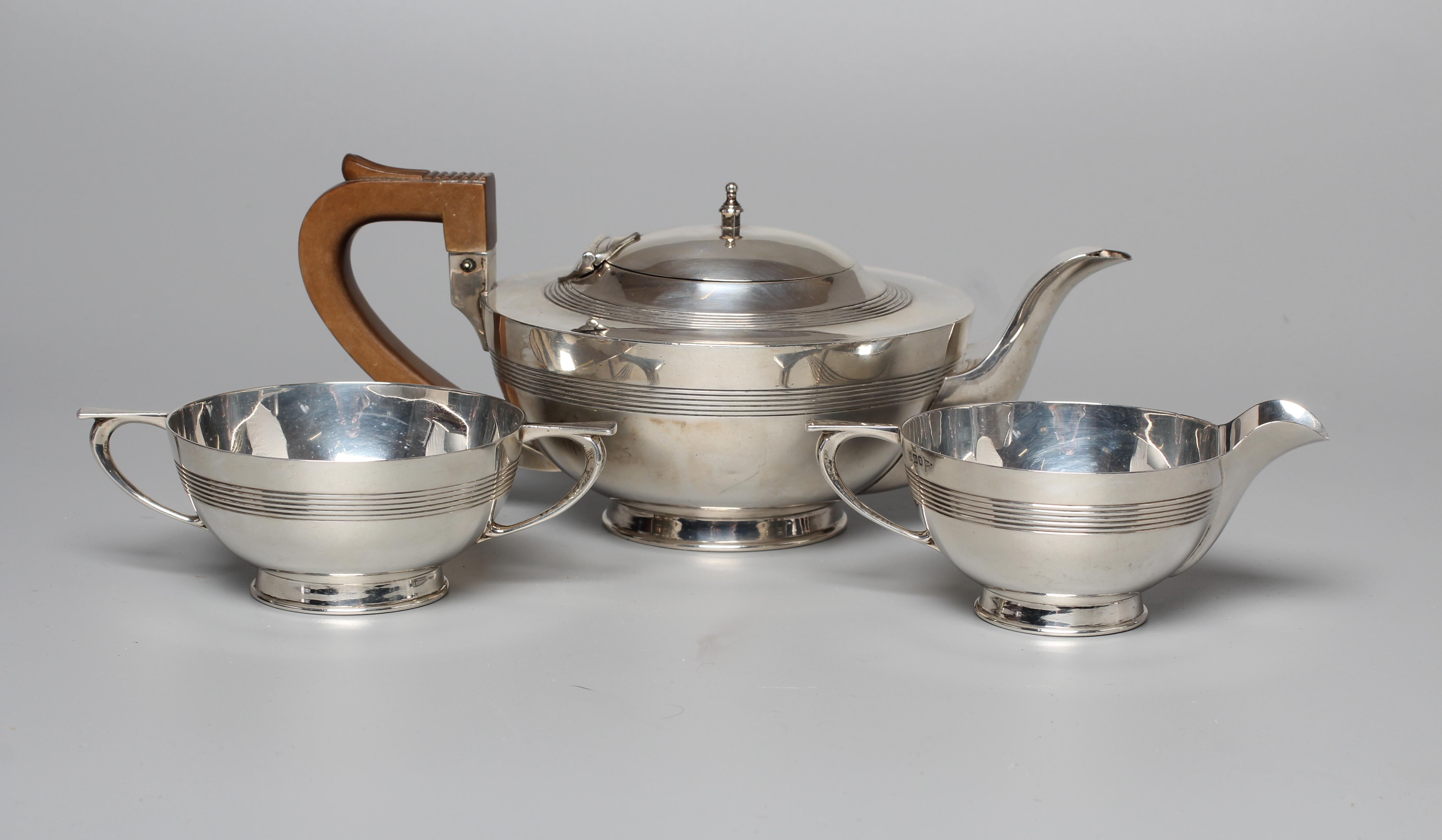 AN EARLY GEORGE V THREE PIECE TEA SERVICE by Walker & Hall Image