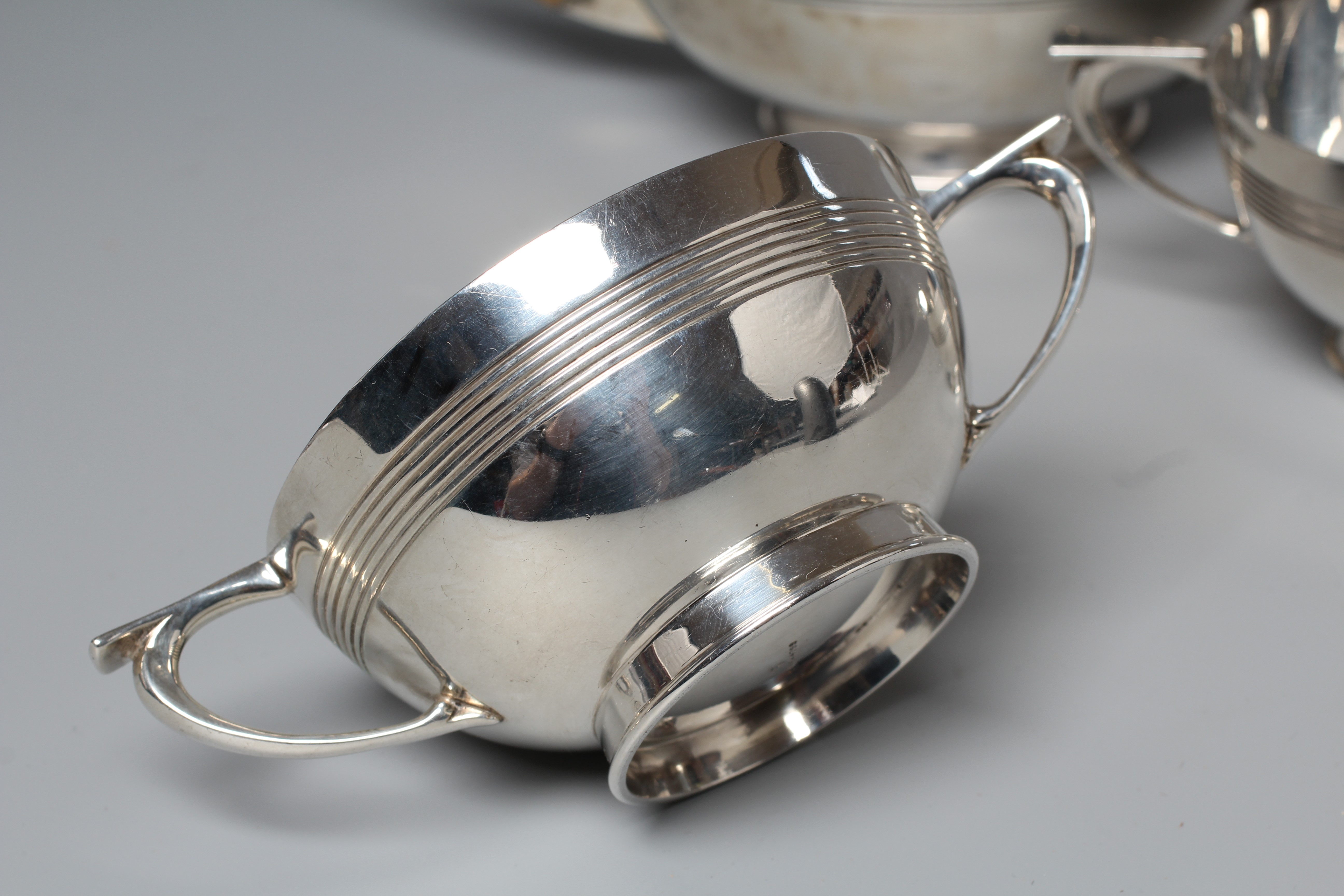 AN EARLY GEORGE V THREE PIECE TEA SERVICE by Walker & Hall Image
