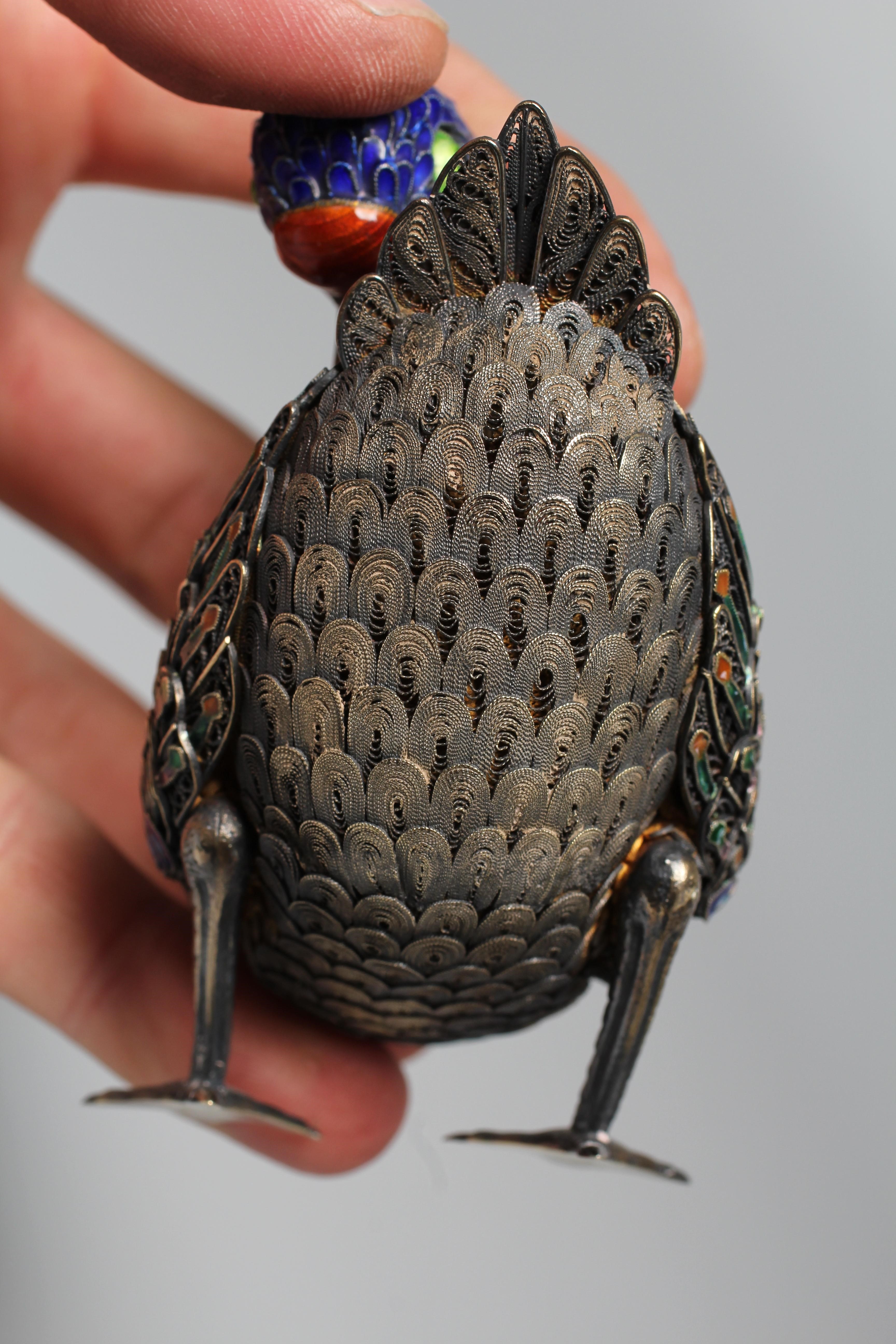 A CHINESE SILVER GILT FILIGREE AND CLOISONNE ENAMEL PREENING DUCK, both feet stamped SILVER, 3 1/22 Image