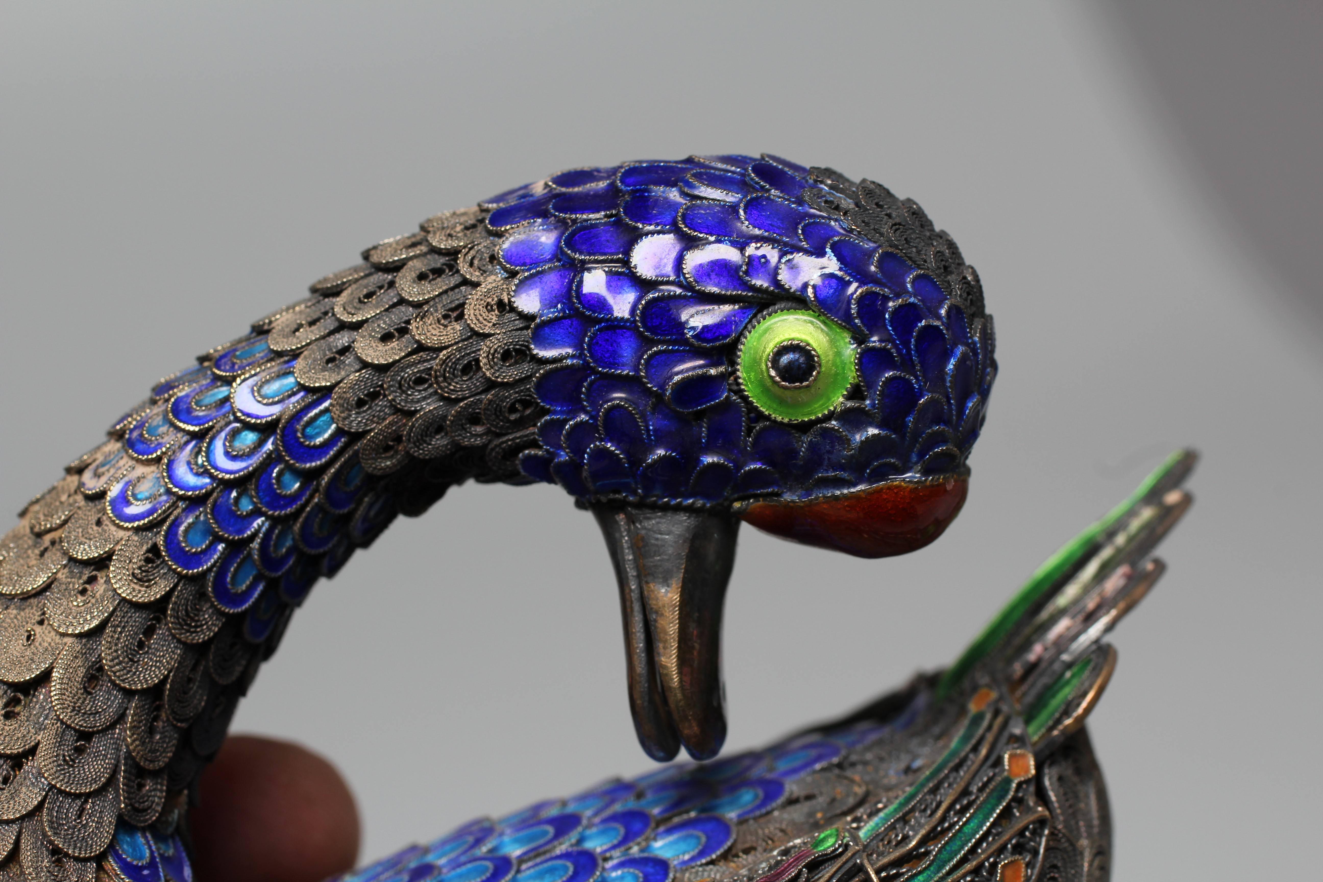 A CHINESE SILVER GILT FILIGREE AND CLOISONNE ENAMEL PREENING DUCK, both feet stamped SILVER, 3 1/22 Image