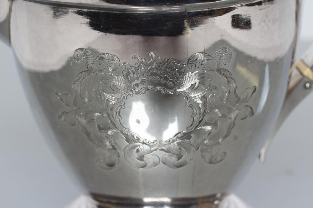 A LATE GEORGE III SILVER HOT WATER JUG Image
