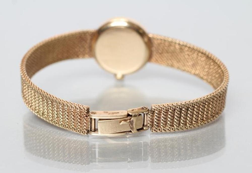 A LADY'S 9CT GOLD OMEGA WRISTWATCH Image