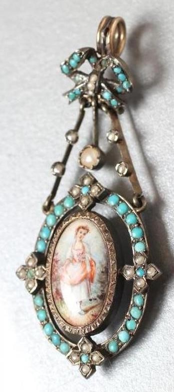 A VICTORIAN PENDANT LOCKET centrally set with an oval enamel plaque painted with two cupids fighting Image