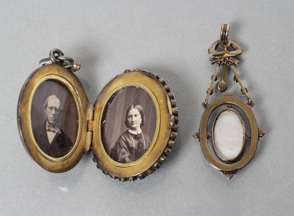 A VICTORIAN PENDANT LOCKET centrally set with an oval enamel plaque painted with two cupids fighting Image