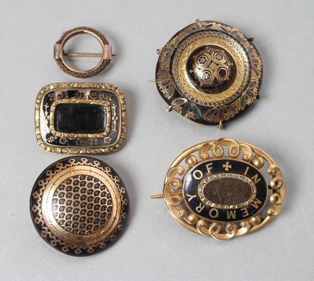 A COLLECTION OF VICTORIAN MOURNING JEWELLERY comprising two pique work tortoiseshell boss brooches Image