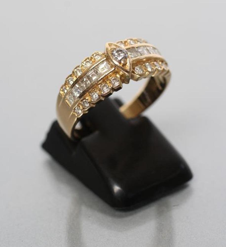 A DIAMOND HALF HOOP RING centred by a round brilliant in a marquise panel with princess cut diamond Image