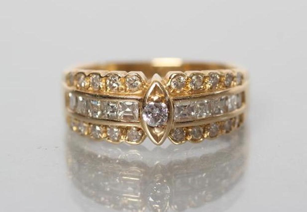 A DIAMOND HALF HOOP RING centred by a round brilliant in a marquise panel with princess cut diamond Image