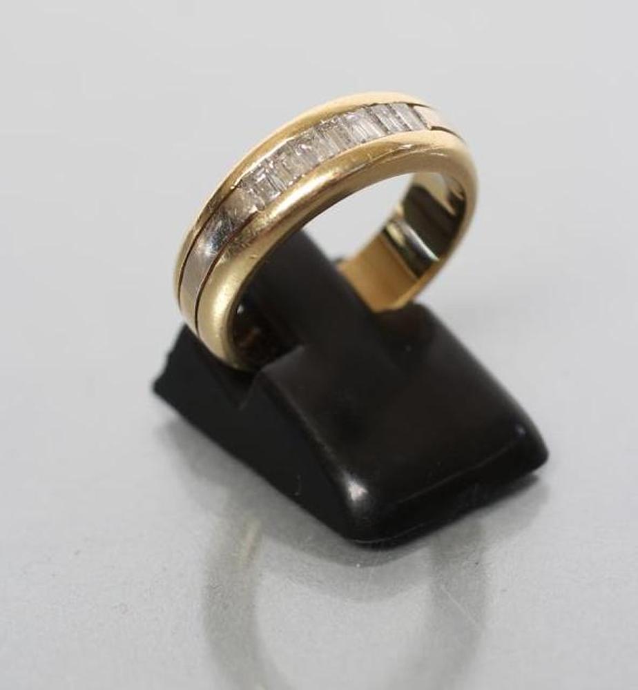 A DIAMOND HALF HOOP RING channel set with seven baguette cut stones to a wide triple shank Image