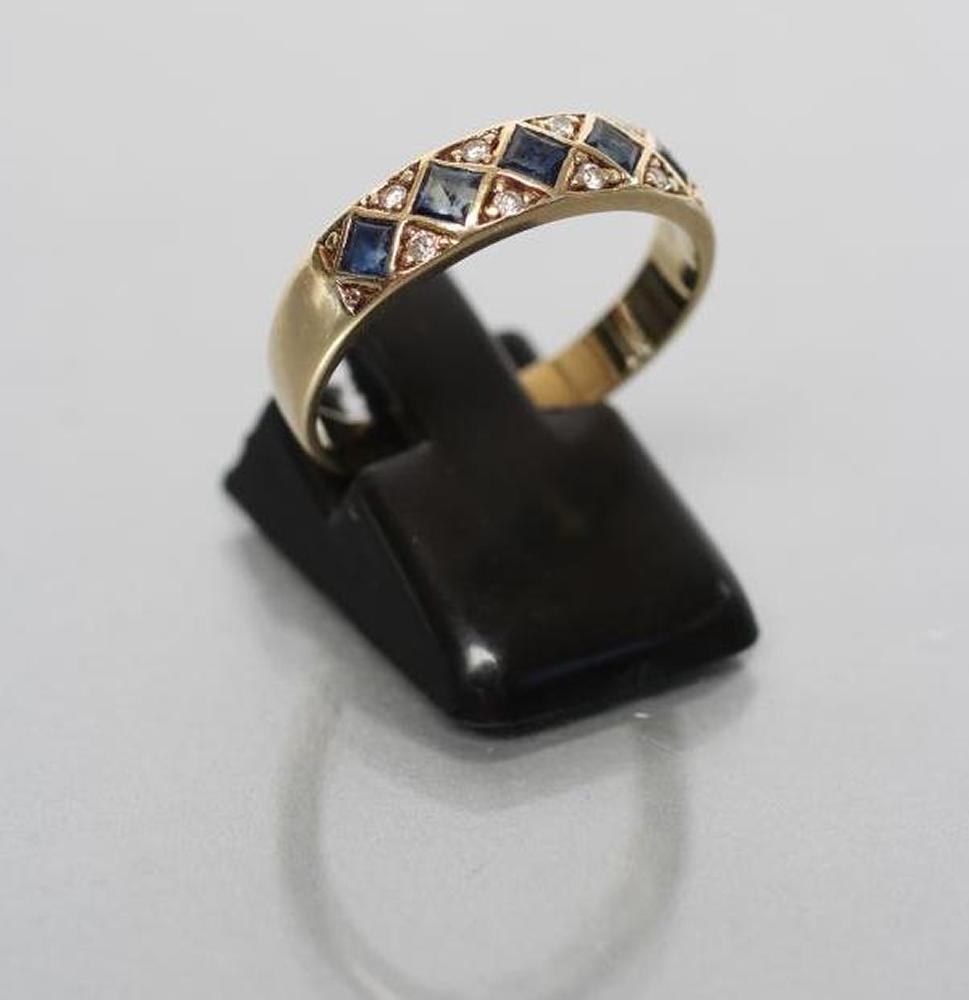 A SAPPHIRE AND DIAMOND HALF HOOP RING set with five square cut sapphires in lozenge panels with Image