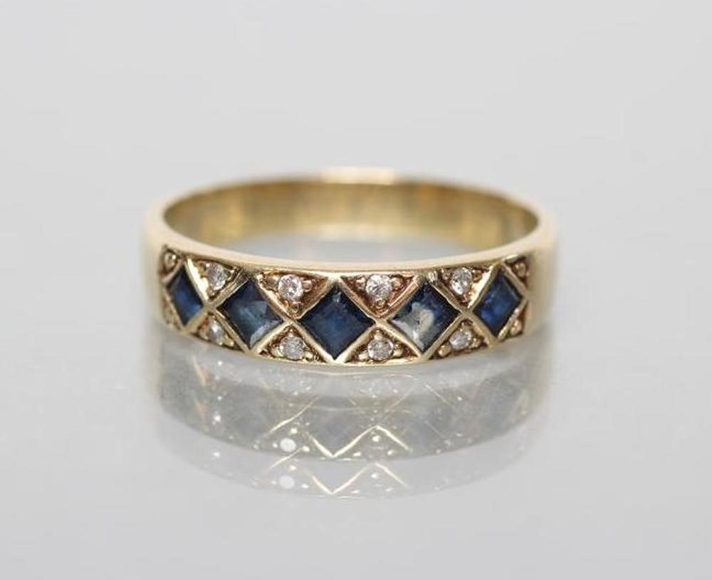 A SAPPHIRE AND DIAMOND HALF HOOP RING set with five square cut sapphires in lozenge panels with Image