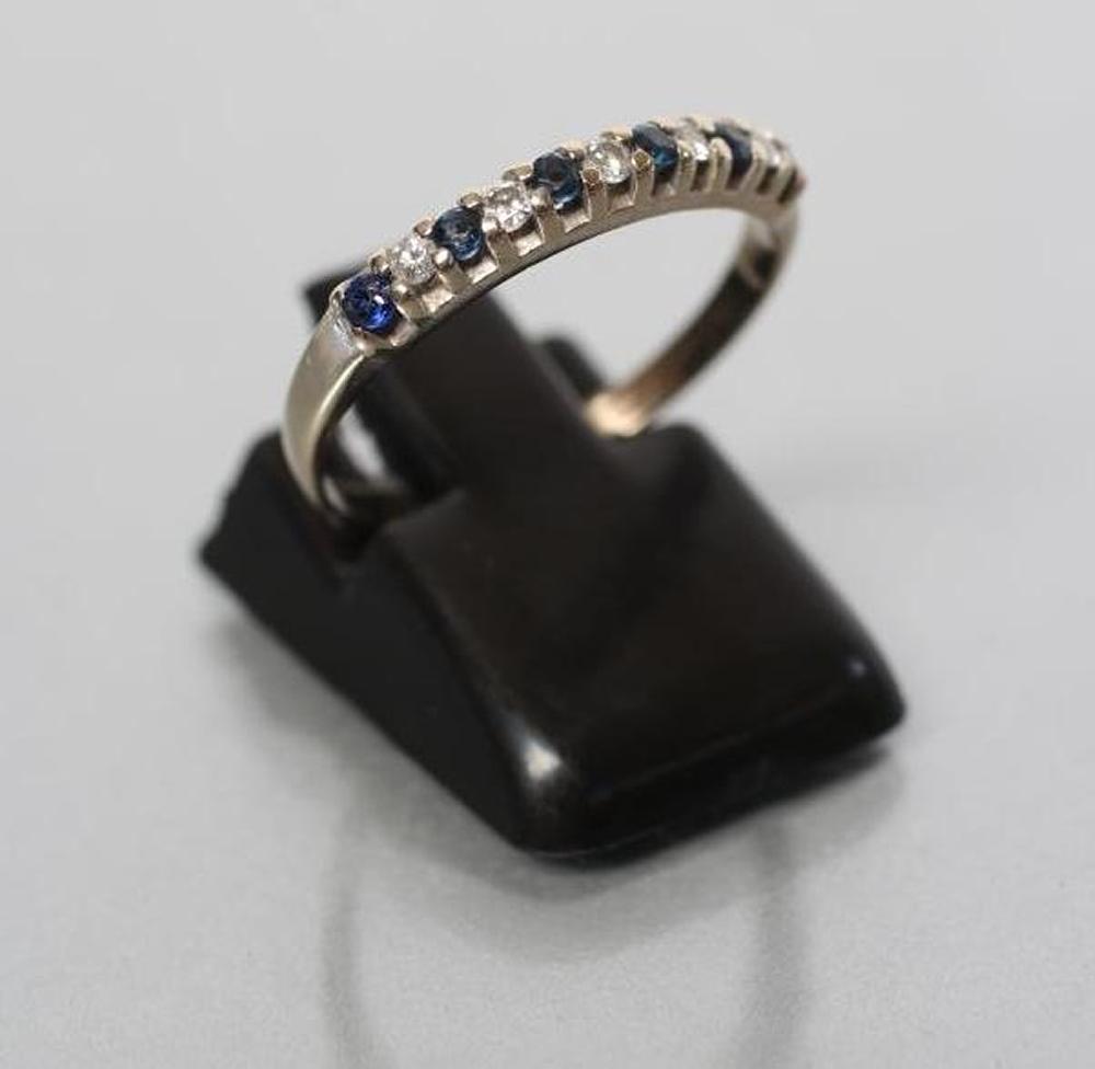 A SAPPHIRE AND DIAMOND HALF HOOP RING Image