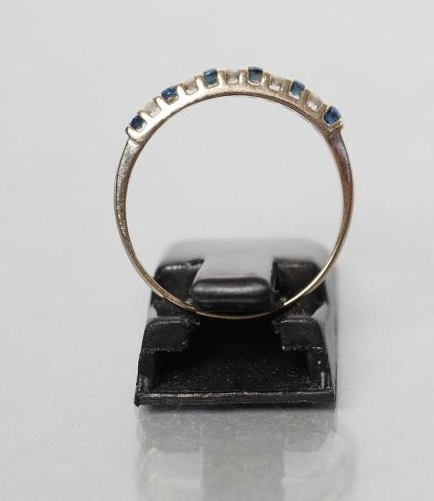 A SAPPHIRE AND DIAMOND HALF HOOP RING Image