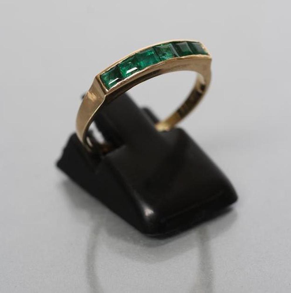 AN EMERALD HALF HOOP RING Image