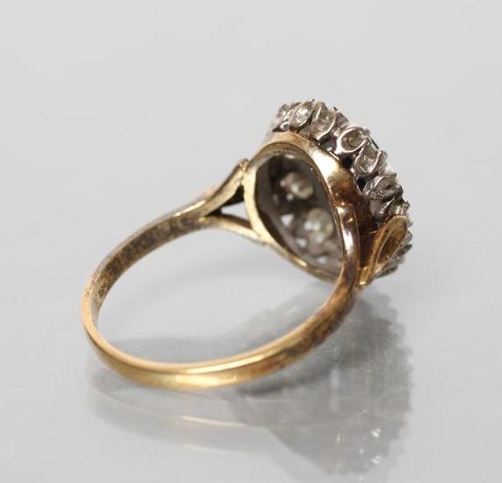 A SAPPHIRE AND DIAMOND CLUSTER RING Image