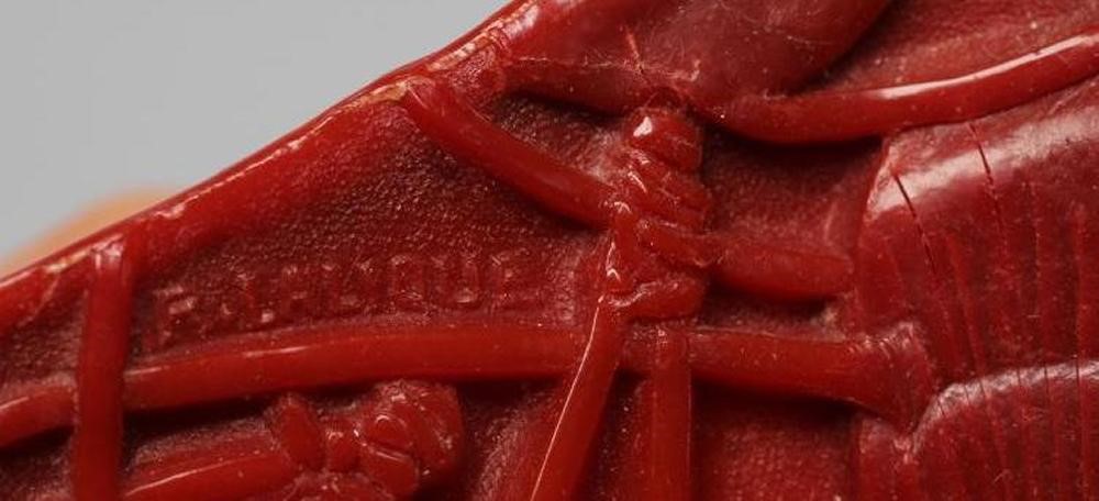 A LALIQUE RED BAKELITE DRESSING TABLE BOX AND COVER moulded in low relief with the "Cerises" pattern Image