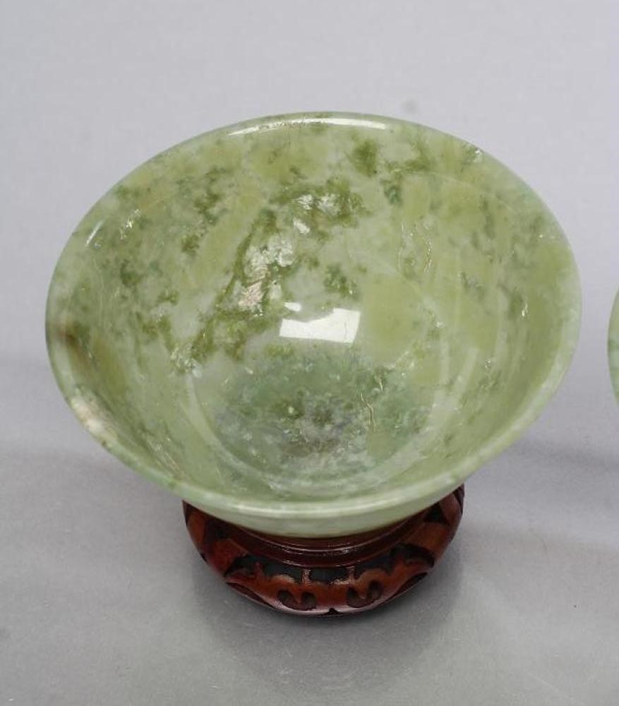 A PAIR OF TURNED AND POLISHED JADE BOWLS of plain circular form Image