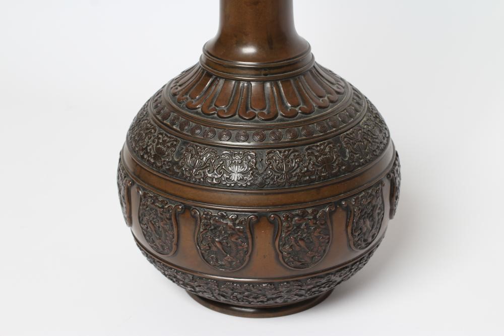 A JAPANESE BRONZE VASE of baluster form with lappet cast neck and girdled base with panels of flora Image