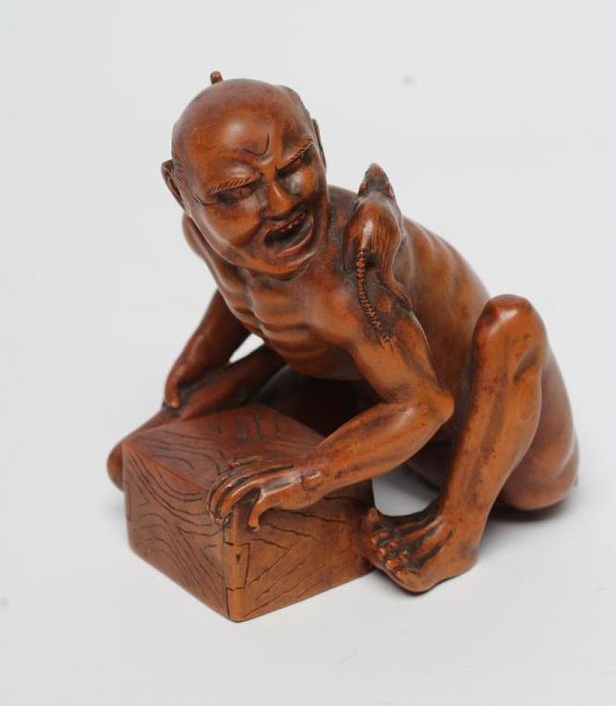 A JAPANESE WOOD OKIMONO carved as a rat catcher Image