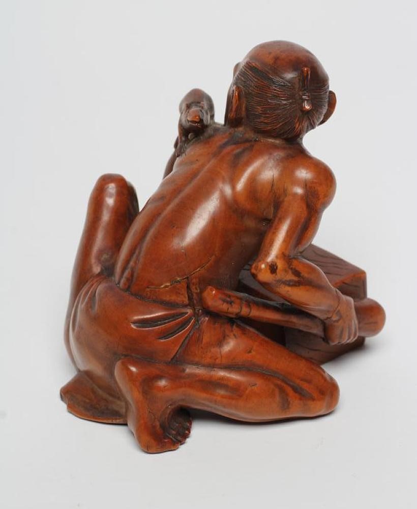 A JAPANESE WOOD OKIMONO carved as a rat catcher Image