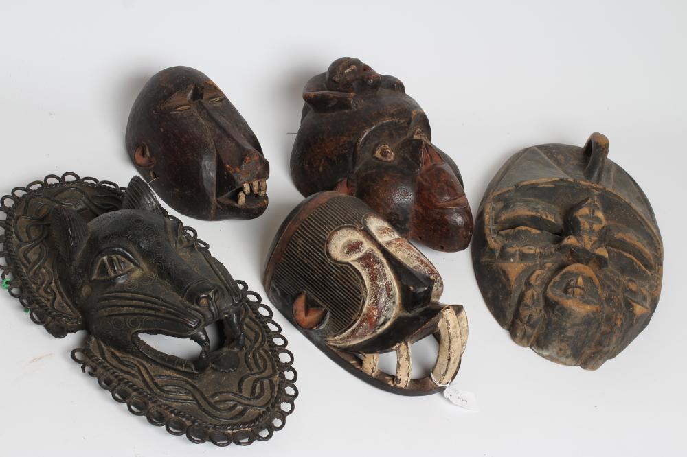 A COLLECTION OF FIVE TRIBAL MASKS Image