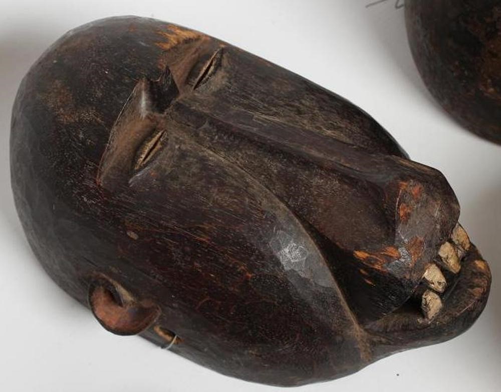 A COLLECTION OF FIVE TRIBAL MASKS Image