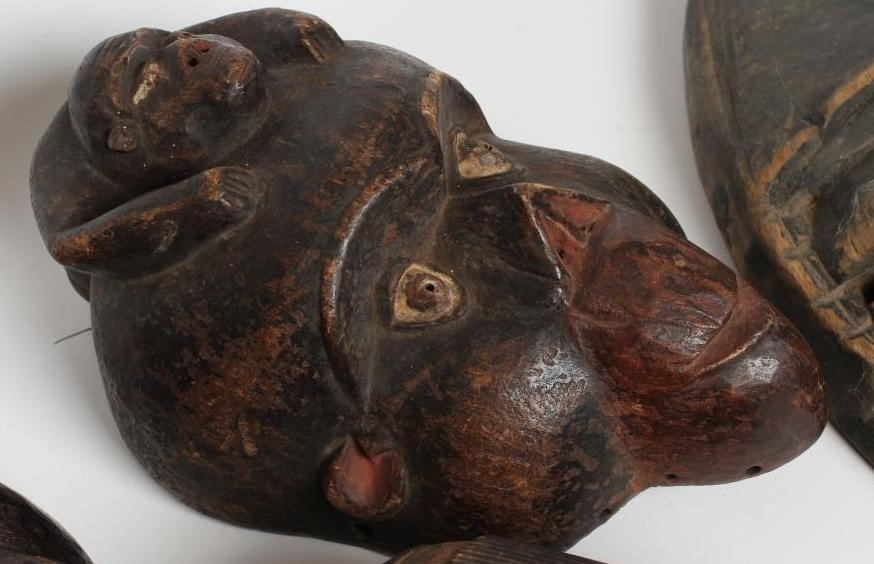 A COLLECTION OF FIVE TRIBAL MASKS Image