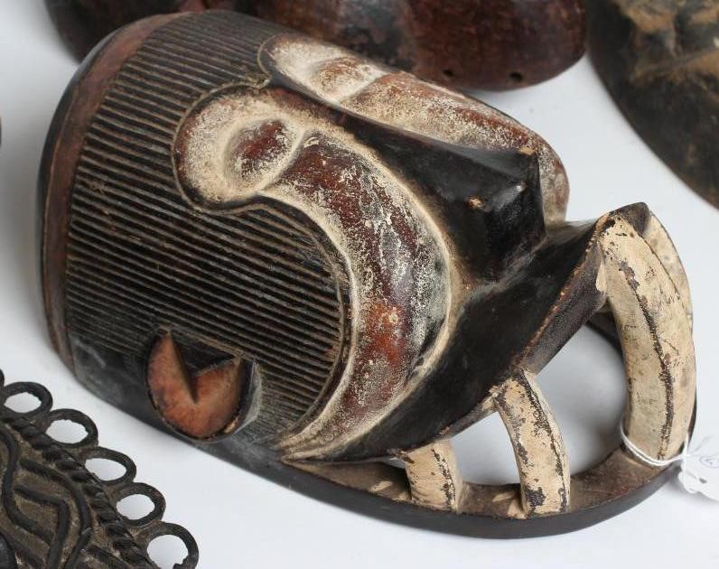 A COLLECTION OF FIVE TRIBAL MASKS Image