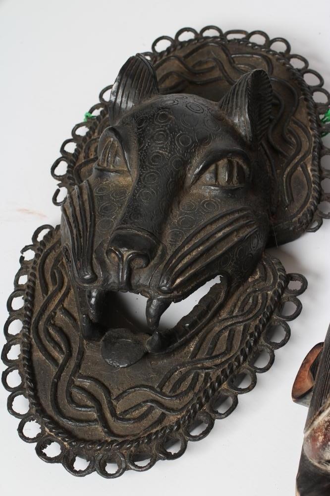 A COLLECTION OF FIVE TRIBAL MASKS Image