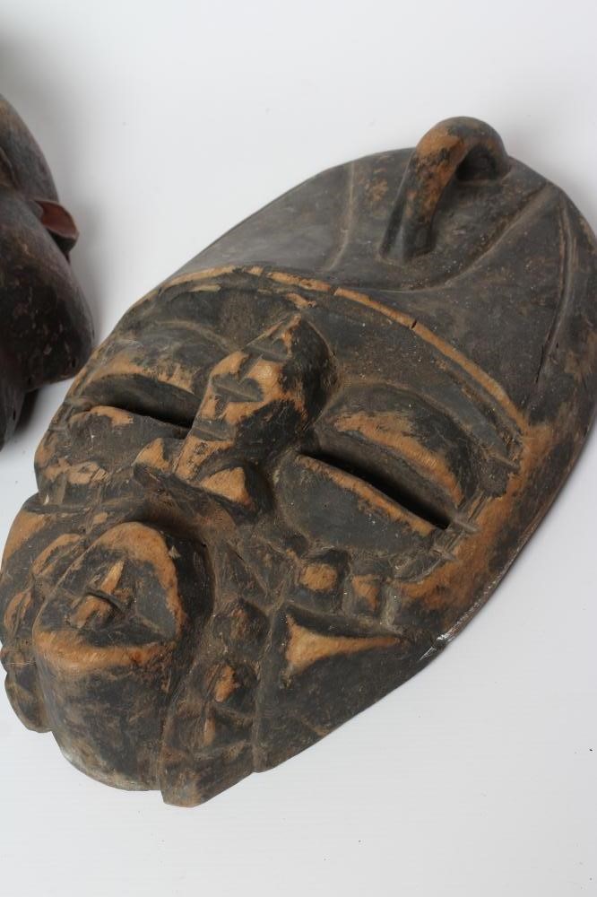 A COLLECTION OF FIVE TRIBAL MASKS Image