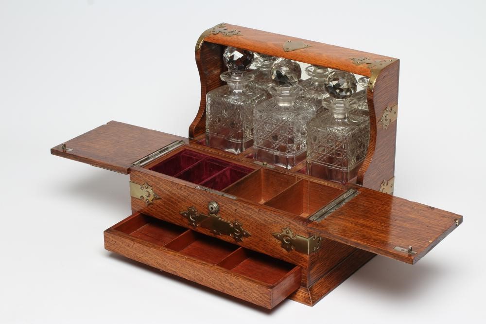 A LATE VICTORIAN OAK TRIPLE TANTALUS Image