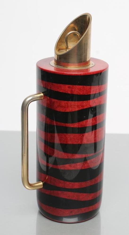AN ITALIAN TURA COCKTAIL FLASK of plain cylindrical form with dark red and black lacquered stripes Image