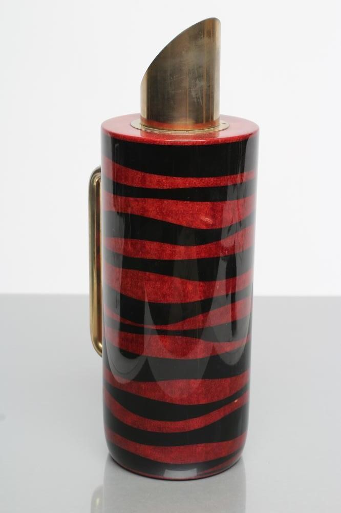 AN ITALIAN TURA COCKTAIL FLASK of plain cylindrical form with dark red and black lacquered stripes Image