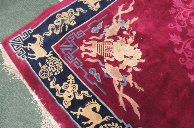 A CHINESE WASHED AND FRINGED CARPET Image